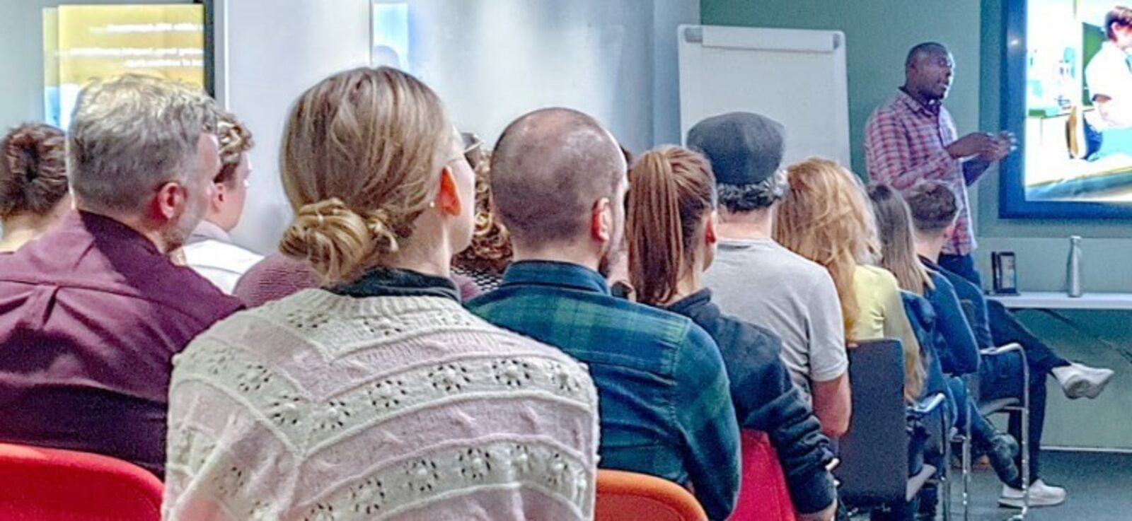 Shayne speaking to a seated audience